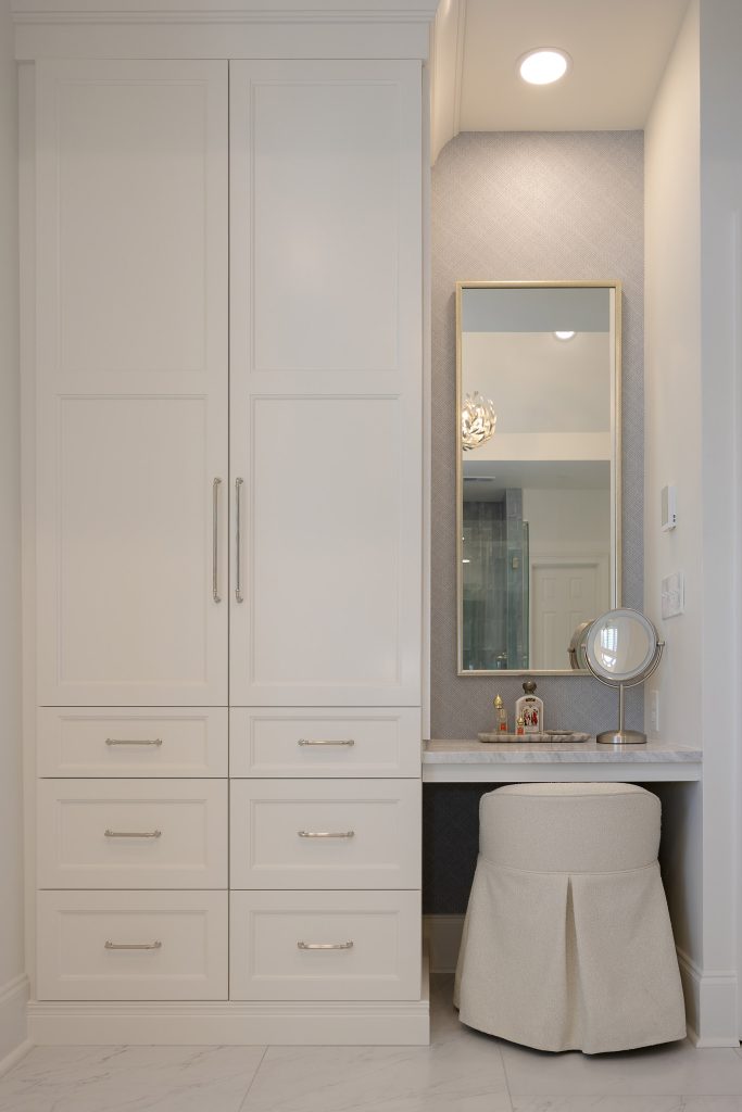 Walk-in shower with blue zellige-look tile, dual showerheads, and a white mosaic floor.