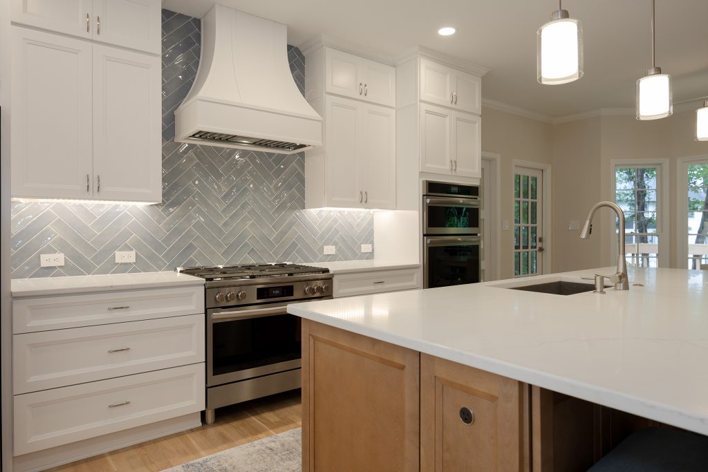 Kitchen from the island corner, with the range wall, double wall ovens and the new door through to the screened porch.