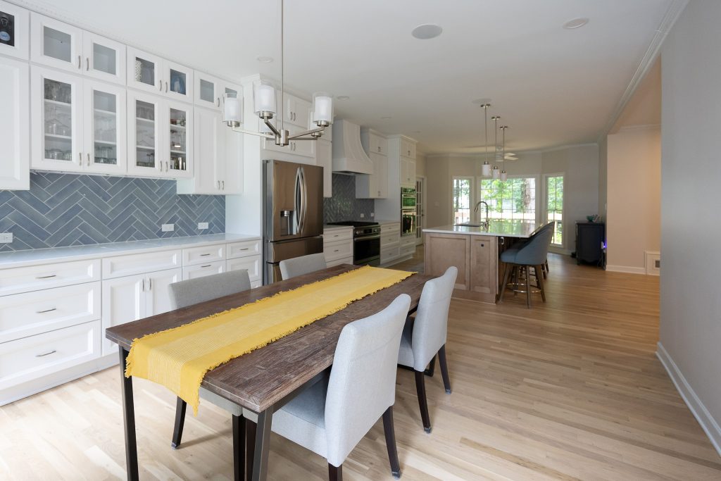 Dining area looking through the open plan to the kitchen island and the family room beyond.